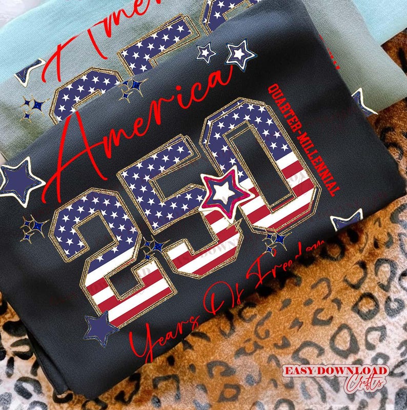 May include: Black sweatshirt with the text "America 250 Years Of Freedom" in red script. The "250" is designed with the American flag pattern. Additional stars in blue and white complete the patriotic design.