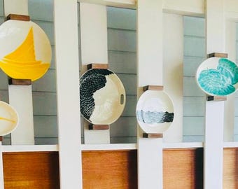 As seen at Kimpton Seafire hotel Cayman Islands 7 mile beach Coccoloba bar and grill 55 plate wall decor