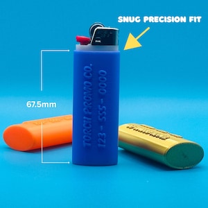 May include: A blue silicone lighter case with the text "TORCH1 PROMO CO. 123-SSS-0000" printed on the side. The case is 6.75 inches tall and has a snug precision fit.