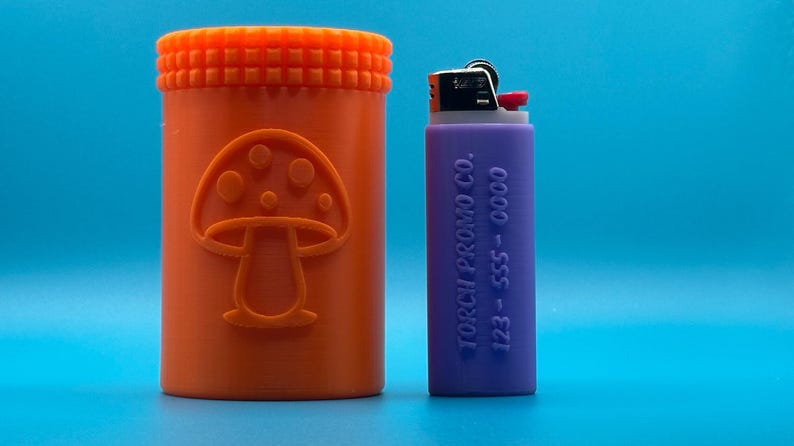 May include: An orange cylindrical container with a mushroom design and a purple lighter with the text "TORCH PROMO CO. 123 - 555 - 0000" on the side.