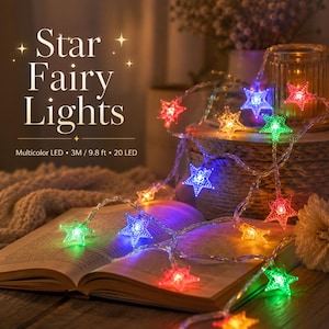 May include: A string of multicolored LED star-shaped fairy lights. The lights are strung on a clear wire and are displayed on an open book. The text on the image reads "Star Fairy Lights" and "Multicolor LED &bull; 3M / 9.8 ft &bull; 20 LED".