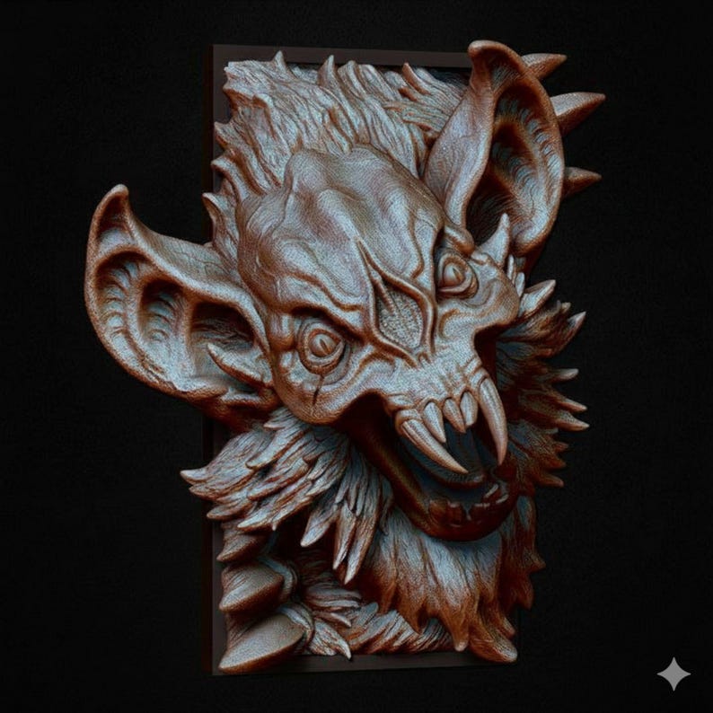 May include: A detailed, bronze-colored wall sculpture of a bat-like creature with sharp teeth and large ears. The sculpture has a textured surface and is mounted on a dark rectangular frame. The creature's face is the focal point.