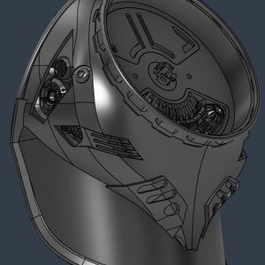 May include: A detailed 3D rendering of a futuristic helmet, showcasing intricate mechanical components and a sleek, dark gray design. The helmet features a visor area, internal mechanisms, and a smooth, curved exterior.