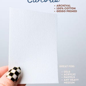 May include: A rectangular white canvas with a textured surface. Text reads: Canvas, ARCHIVAL, 100% COTTON, GESSO PRIMED, GREAT FOR: OILS, ACRYLIC, PASTELS, ANY HEAVY MEDIUM. The canvas is held up against a plain background, showcasing its weave.