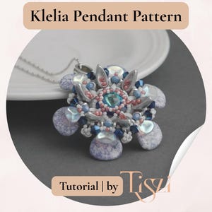 May include: A close-up of a pendant necklace with a floral design. The pendant features a central turquoise bead surrounded by pink, blue, and silver beads. The text "Klelia Pendant Pattern" is at the top.