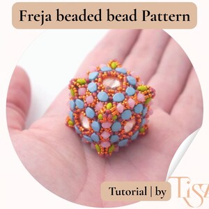 May include: A beaded bead pattern in a cube shape, featuring a mix of colors including orange, blue, pink, and green. The text "Freja beaded bead Pattern" is at the top, and "Tutorial | by Tiszti" is at the bottom.
