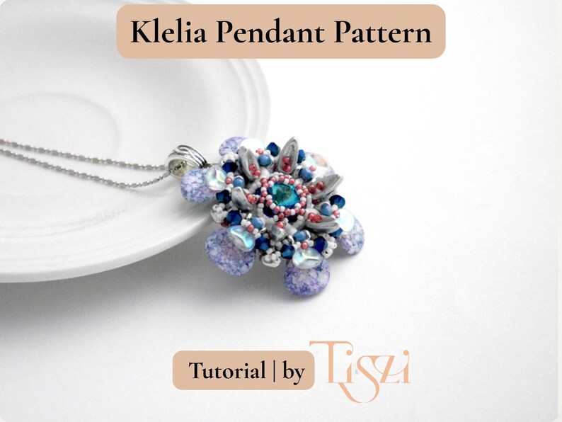 May include: A beaded pendant necklace with a floral design. The pendant features a central teal-colored bead surrounded by silver, blue, and red accents. The necklace is on a silver chain. Text on the image reads "Klelia Pendant Pattern" and "Tutorial | by Tiszi".