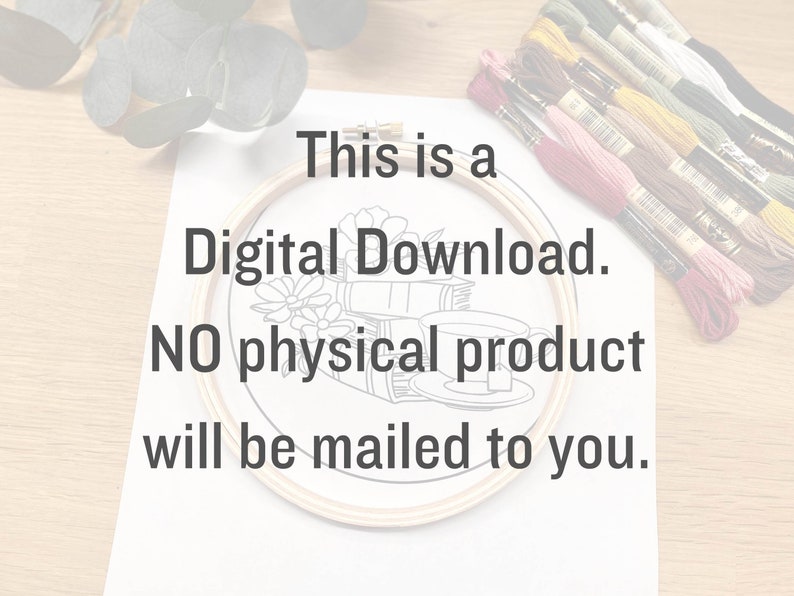 May include: A white sheet of paper with the text "This is a Digital Download. NO physical product will be mailed to you." printed on it. A wooden embroidery hoop with a black and white line drawing of a cup of tea and books is on the paper. A bundle of embroidery floss is on the right side of the paper.