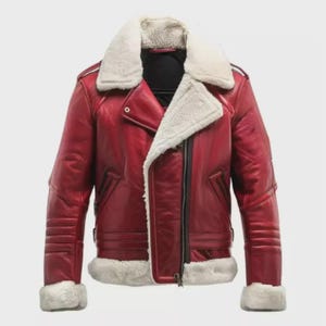 May include: A red leather jacket featuring a thick white faux shearling collar, cuffs, and hem. The jacket includes an asymmetrical front zipper closure, long sleeves with ribbed detailing on the upper arms, and a black interior lining.