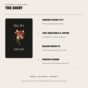 May include: A black t-shirt featuring a cartoon bull wearing a vest and holding a teacup, with the text BULL IN A CHINA SHOP. The graphic is printed on a 6.1 oz heavyweight ring-spun cotton shirt with a relaxed fit, available in pepper, blue spruce, or navy.