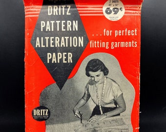 May include: A red and black package of Dritz Pattern Alteration Paper. The package shows a woman using the paper to alter a pattern. The text on the package reads "Dritz Pattern Alteration Paper... for perfect fitting garments". The package contains two sheets of paper, each measuring 40 inches by 54 inches. The price is 69 cents.