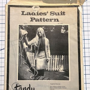 May include: A vintage sewing pattern for a ladies' suit. The pattern is from Tandy Leather Company and is for size 8. The pattern number is 2681. The pattern features a photo of a woman wearing a skirt and jacket made from leather. The suggested materials are New Zealand Lambskin Suede, Sheer Lambskin Suede, and Garment Cabretta. The pattern also includes instructions for lining the skirt and using rubber cement.
