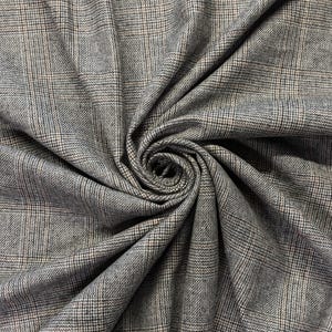 May include: Close-up of a gray fabric with a plaid pattern. The fabric has a woven texture with a mix of gray, black, and beige threads. The plaid design is a classic pattern, suitable for apparel or home decor.