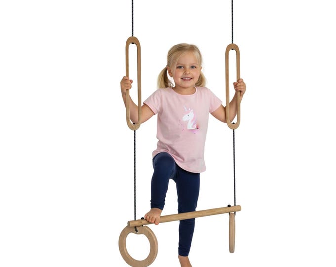 Trapezoid with eyelets at the top and bottom. A trapeze that can be used for swinging while standing, a birthday present for active children, an indoor trapeze.