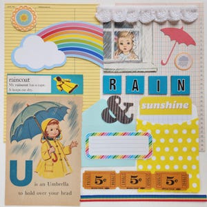 May include: A collage featuring a rainbow, a child in a yellow raincoat with an umbrella, the text 'rain', 'sunshine', and 'U is an Umbrella', a white eyelet trim, three 5-cent tickets, a yellow polka dot pocket, and various paper ephemera.