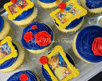 May include: A collection of cupcakes with blue frosting and red icing roses. Some cupcakes feature edible rectangular frames with printed character illustrations. The text Sugar Mama's Treats is visible in the center of the cupcake arrangement.