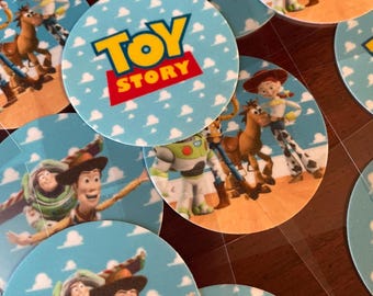 May include: Round edible images featuring characters from the Toy Story movie franchise. The images are printed on a white background with blue clouds. Some images feature Woody, Buzz Lightyear, and Jessie. One image features the Toy Story logo with the text "Toy Story".