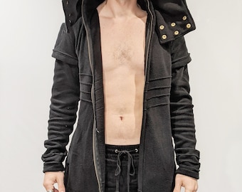 May include: A black hooded long-sleeved jacket with a zip closure and gold-coloured snaps. The jacket has a long, flowing design and is made of a soft, comfortable fabric.
