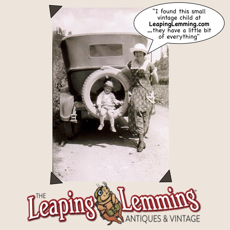 May include: Vintage black and white photograph featuring a woman and a child posing near a vintage car. The child is seated in the spare tire. Text in a speech bubble reads: "I found this small vintage child at LeapingLemming.com...they have a little bit of everything."
