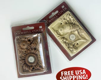 May include: Two ceramic doorbell covers in packaging. One features a sunflower design, the other a bird on a branch. Both have a white doorbell button. The packaging reads "Ceramic Doorbell Cover".