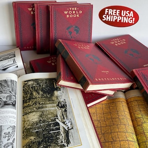 May include: A collection of vintage "The World Book" encyclopedias. The books have red covers with gold lettering and a globe emblem. Open books display black and white images and maps.