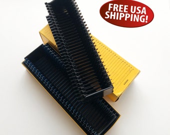 May include: A set of 36 black slide storage trays in two yellow boxes. The boxes are labeled "INOX" and have numbers printed on the side.