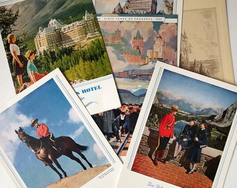 May include: A vintage postcard featuring a view of the Banff Springs Hotel in the Canadian Rockies. The postcard shows the hotel in the distance with mountains in the background. The text on the postcard reads "Bow Valley from the Terrace Banff Springs Hotel Canadian Rockies".