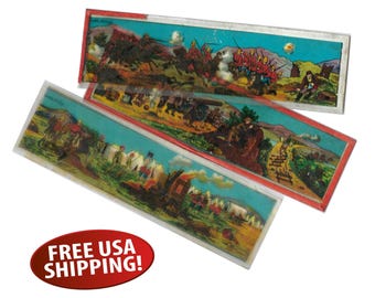 May include: Three antique, rectangular optical viewer cards with colorful illustrations of historical battle scenes. The cards have a red border and are in a clear plastic sleeve. The cards depict soldiers, horses, and cannons.