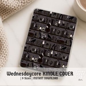 May include: A Kindle cover with a dark gray bookshelf design. The cover features illustrations of books, crows, lamps, and musical instruments. The text "Wednesdaycore Kindle Cover" is displayed at the bottom.