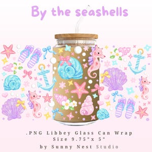 May include: A Libbey glass can wrap featuring a seashell theme. The design includes illustrations of seashells, seahorses, anchors, and flip-flops in pastel colors. The text "By the seashells" is at the top. The wrap is 9.75" x 5".