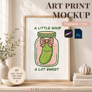 May include: A digital art print mockup featuring a green cartoon pickle inside a glass jar with a pink bow. The text reads A LITTLE SOUR at the top and A LOT SWEET at the bottom. The design includes Procreate and PSD icons, with additional text stating ART PRINT MOCKUP and EASY TO USE FOR YOUR DESIGNS.