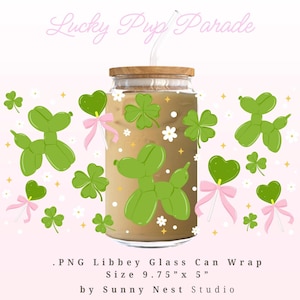 May include: A clear glass can-shaped cup with a wooden lid, filled with a light brown beverage. The cup is decorated with green balloon dog shapes, shamrocks, and pink bows. The text "Lucky Pup Parade" is at the top.