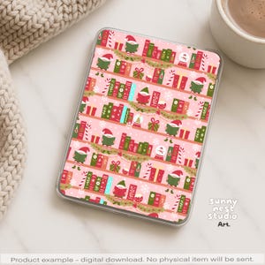May include: A pink digital tablet case with a repeating Christmas-themed pattern. The design includes elves, books, candy canes, and snow. The case has a clear border. The text "Sunny nest studio Art" is visible. The design is festive.
