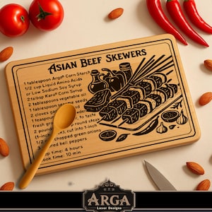 May include: Wooden chopping board with the text "ASIAN BEEF SKEWERS" and a recipe illustration. The board features a wooden spoon, a knife, almonds, and red chillies. The board is made by ARGA Laser Designs.