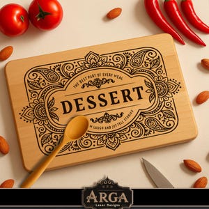 May include: A rectangular wooden cutting board with the word "DESSERT" in a decorative frame. The board has the text "THE BEST PART OF EVERY MEAL" and "M LAUGH AND JUT TELL STORIES". A wooden spoon and almonds are also visible.
