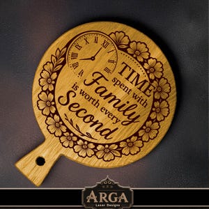 May include: Wooden serving board with a handle, featuring a clock design and the quote "Time spent with family is worth every second." The board is decorated with floral patterns and Roman numerals. The brand logo is at the bottom.