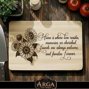 May include: A rectangular wooden cutting board with a sunflower design and the text "Home is where love resides, memories are cherished, friends are always welcome, and families forever." The board has a curved handle.