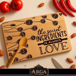 May include: A rectangular wooden cutting board with the text "the secret ingredients is always LOVE" in black. The board has a floral design and a wooden spoon. Red tomatoes, chili peppers, and almonds surround the board.