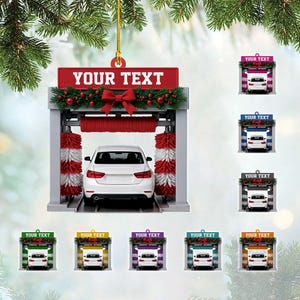 May include: A car wash ornament with a white car inside. The ornament has a red banner that says "YOUR TEXT" and is decorated with a red bow and greenery. Additional ornaments with the same design are shown.