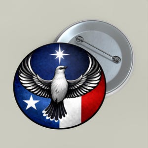 May include: A round button pin featuring a white bird with outstretched wings, set against a backdrop of blue, white, and red. A white star is above the bird. A second, unattached button pin is visible.