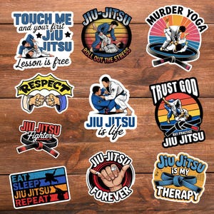 May include: A collection of colorful Jiu-Jitsu stickers with various designs and text. The stickers feature illustrations of martial arts techniques, phrases like "Touch Me and Your First Jiu Jitsu," and "Jiu Jitsu is Life." The stickers are on a wooden background.
