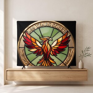 May include: A rectangular wall tapestry featuring a circular emblem with a stained glass effect. The design displays a central phoenix with red, orange, and yellow wings against a light green background. The text 1-99 YEARS SOBER is arched above.