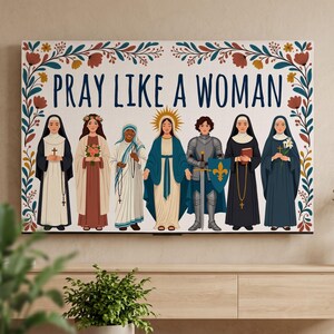 May include: A rectangular wall art print featuring the text PRAY LIKE A WOMAN in dark blue letters. The design includes a floral border and seven illustrated figures, including nuns, a saint, the Virgin Mary, and a knight in armor with a sword.