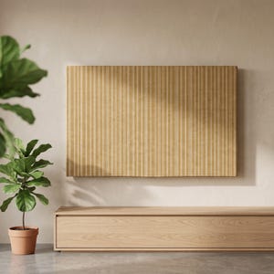 May include: A rectangular wall art piece featuring a mustard yellow background with vertical white pinstripes. The artwork is mounted on a wall above a light-toned wooden media console, with a potted fiddle leaf fig plant positioned to the left.