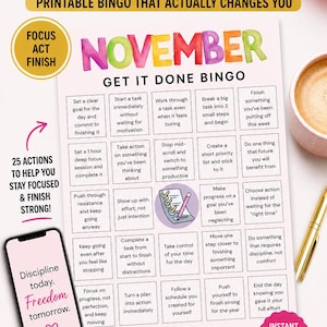 May include: Printable November bingo game with a pink and white theme. The bingo card includes prompts for productivity and goal setting. A smartphone displays the text "Discipline today. Freedom tomorrow."