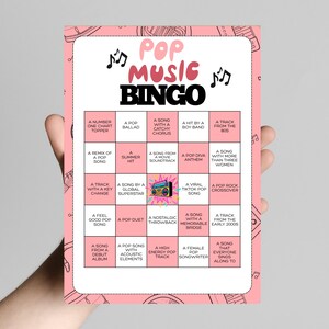 May include: Pink Pop Music Bingo card with musical notes and the title "Pop Music Bingo". The card features a grid of squares with various music-related prompts, such as "A Song with a Catchy Chorus" and "A Viral TikTok Pop Song".
