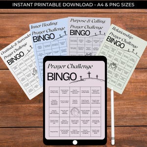 May include: A digital download featuring a Prayer Challenge Bingo game. The image shows a tablet displaying the game, surrounded by printed bingo cards with titles like "Gratitude & Surrender" and "Inner Healing." A white stylus rests nearby. The text "INSTANT PRINTABLE DOWNLOAD" is at the top.