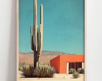 May include: A framed art print featuring a desert landscape with a large saguaro cactus, orange building, and blue sky. The artwork has a minimalist style with a mid-century modern aesthetic. The print is in a wooden frame.