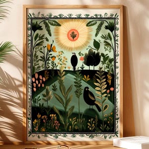 May include: A framed art print with a colourful illustration of a landscape, featuring two black birds. The artwork includes a sunburst design, lush greenery, and flowers, all within a decorative border. The print is set in a wooden frame.