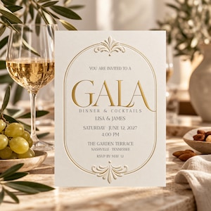 May include: A cream-colored invitation card featuring a gold foil-stamped oval border with decorative flourishes. The text reads: YOU ARE INVITED TO A GALA DINNER & COCKTAILS, LISA & JAMES, SATURDAY JUNE 12, 2027, 4:00 PM, THE GARDEN TERRACE, NASHVILLE, TENNESSEE, RSVP BY MAY 12.